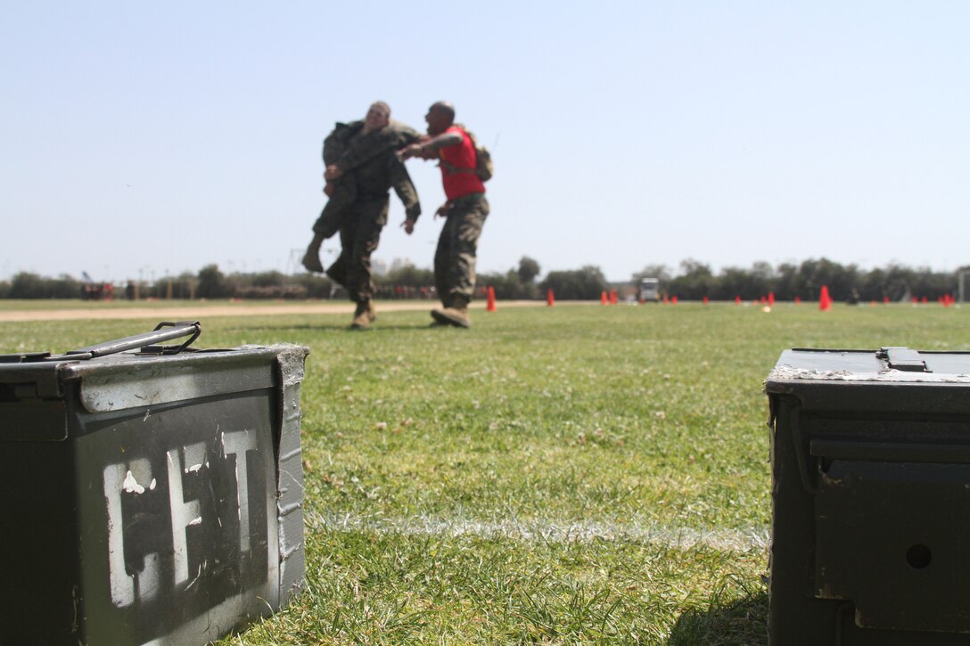 A drill instructor with Company C, 1st Recruit Training Battalion, encourages his recruit during the fireman's carry portion of the Combat Fitness Test April 14. The CFT is an annual training requirement for all Marines to ensure they're able to endure the rigors of combat.