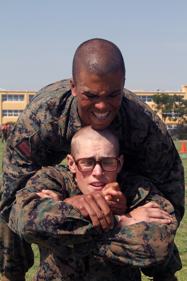Recruit Jonathon Glenn lifts Recruit Alexander Edwards, both of Company C, 1st Recruit Training Battalion, during the Combat Fitness Test. The CFT is an annual training requirement for all Marines to ensure they’re able to endure the rigors of combat.