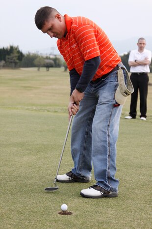 Josh D. Bradford, a competitor, sinks the putt that won the overall title for his team during the 2011 Boy Scouts of America Golf Tournament at the Torii Pines Golf Course here April 15. Bradford and his team played well throughout the entire event.