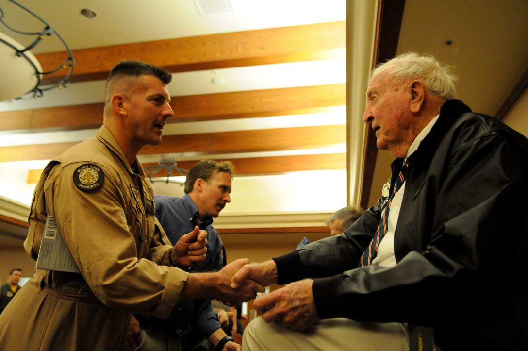 Harry Johnson, original Marine Attack Squadron 214 pilot, shakes hands with Lt. Col. Gary Roesti, Marine Aircraft Group 13 headquarters element commanding officer, during a dinner for the Black Sheep reunion hosted by the Marine Corps Aviation Association at the Sonoran Pueblo April 14, 2011. Johnson, Jim Hill and Ed Harper, all original Marine Attack Squadron 214 pilots and three of the only five still remaining, attended the event. All served under Medal of Honor recipient and first Black Sheep commanding officer Gregory “Pappy” Boyington during the squadron’s first combat deployment in the Pacific in 1943.