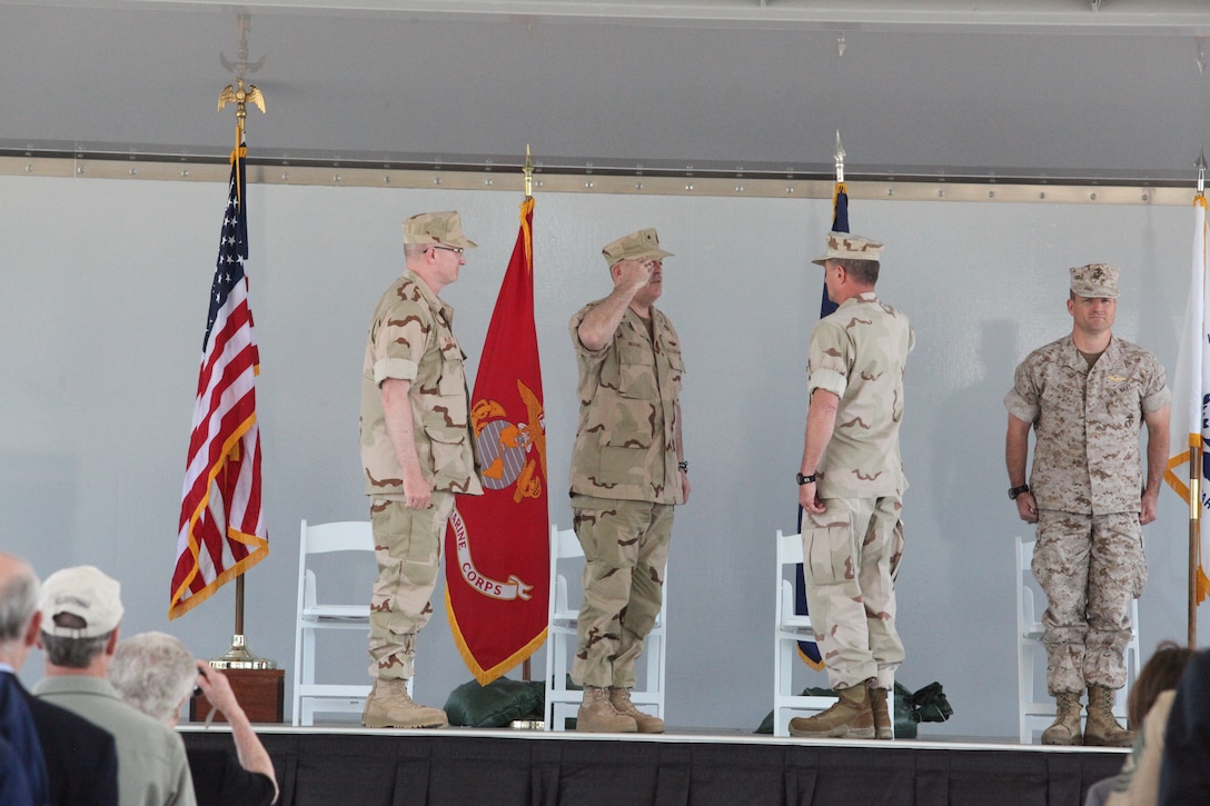 Coast Guard Capt. Mark J. Wilbert, (left) the incoming commanding officer for The Joint Maritime Training Center, aboard Marine Corps Base Camp Lejeune, stands at attention as Coast Guard Rear Adm. Stephen Mehling, (center) commander of Force Readiness Command relieves Capt. Steve Weiden (right) of his command during the change of command ceremony, April 15.