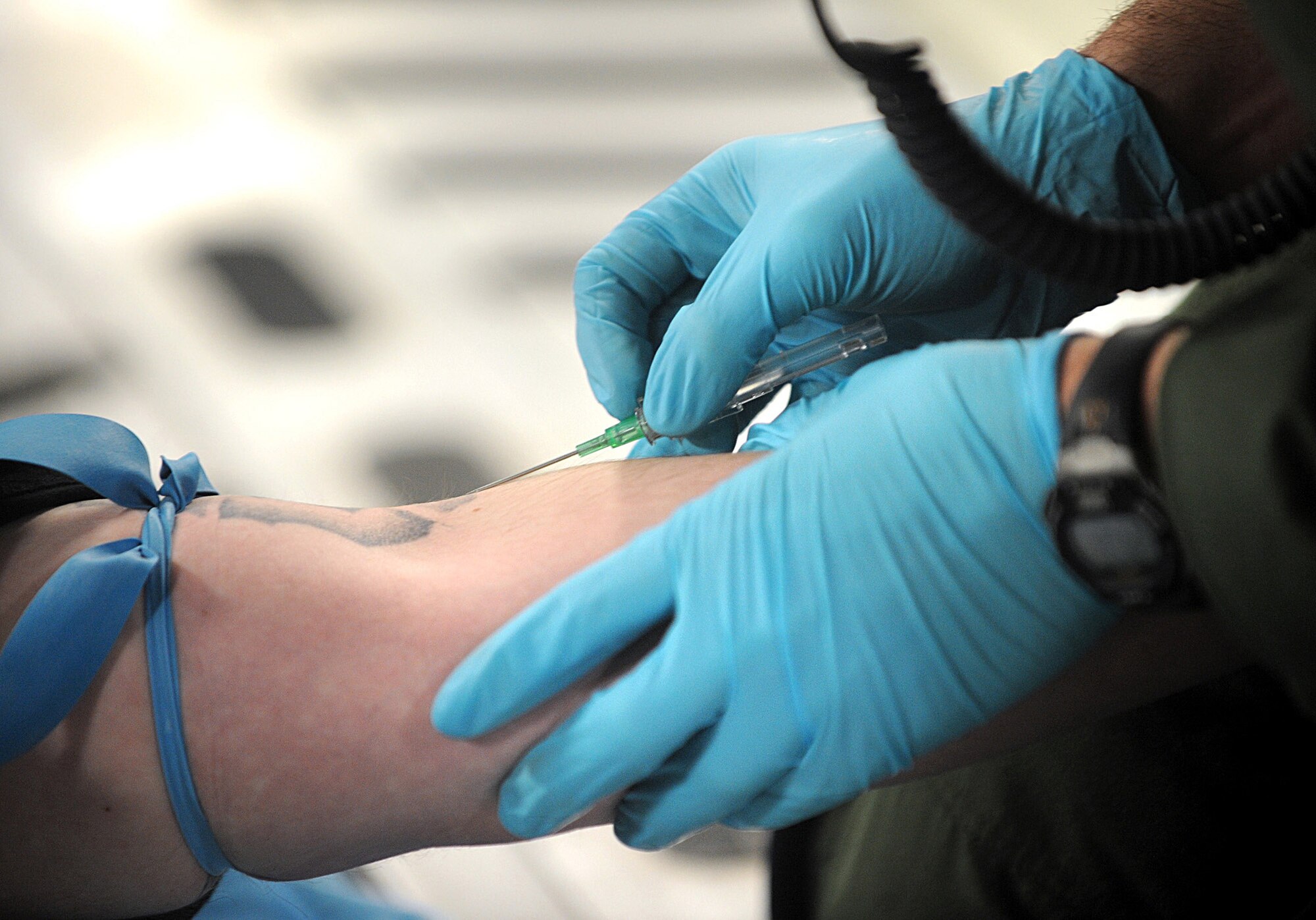 Air Force Reserve Senior Airman Benjamin Heder preps Tech .Sgt. Larry Jones for an IV during a 446th Aeromedical Evacuation Squadron training flight March 31 aboard a C-17 Globemaster III over Washington state.  The 446th AES is assinged to McChord Field, Wash. (U.S. Army photo by Ingrid Barrentine)