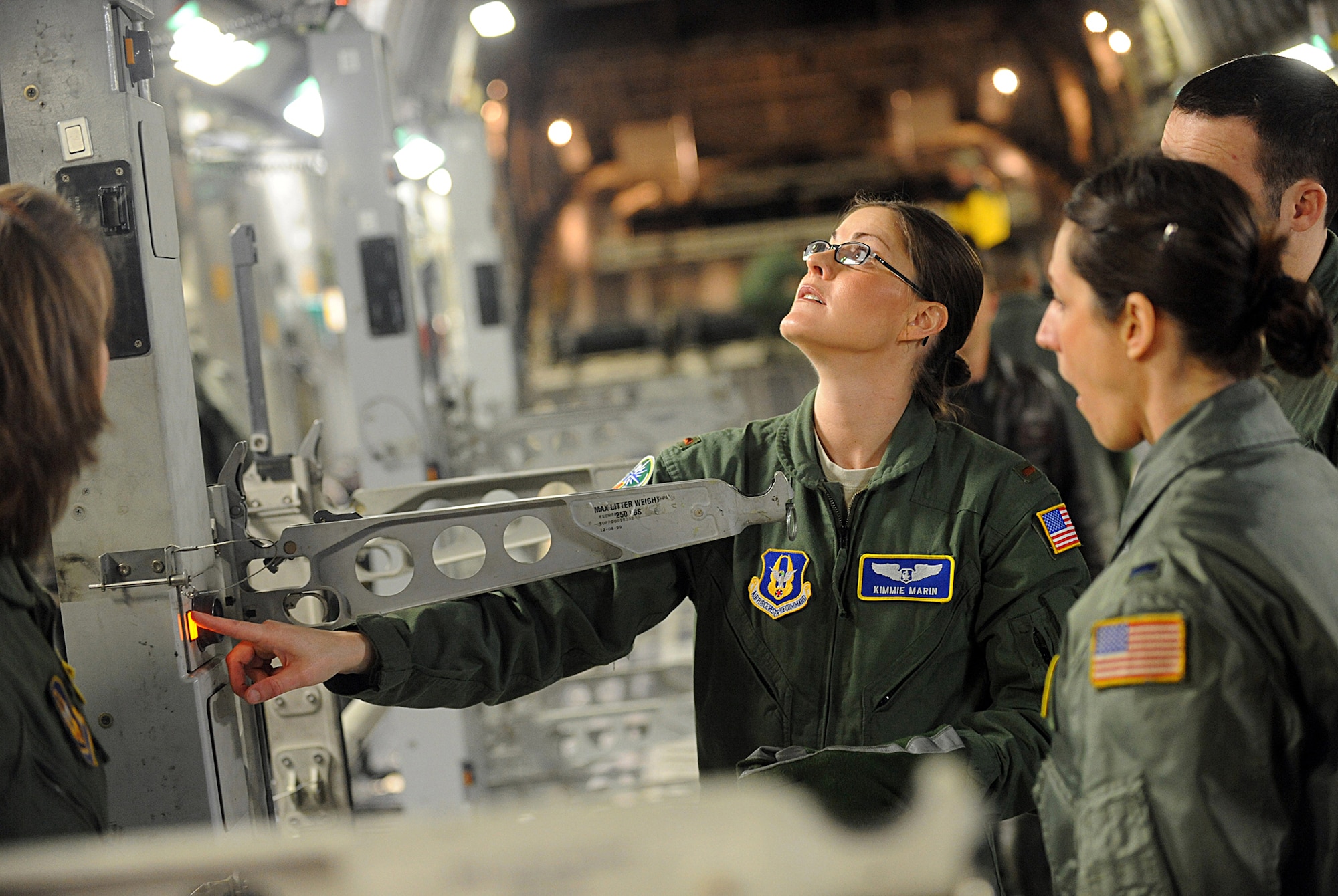 Air Force Reserve 2nd Lt. Kimmie Marin, a flight nurse with the 446th Aeromedical Evacuation Squadron, McChord Field, Wash., checks to see that the nurses call light is working during a  training flight March 31 aboard a C-17 Globemaster III over Washington state. (U.S. Army photo by Ingrid Barrentine)
