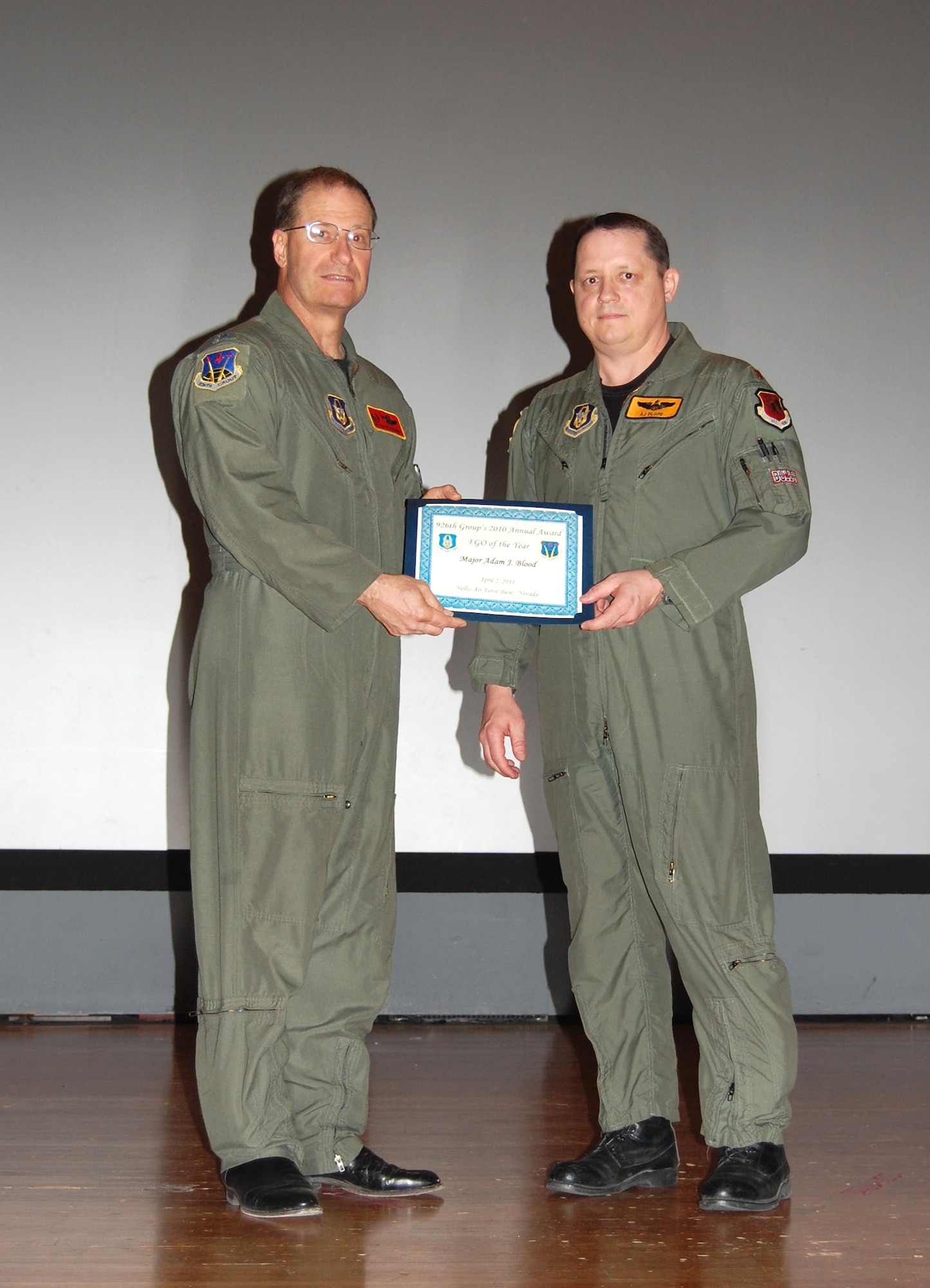 NELLIS AIR FORCE BASE, Nev. -- (Right) Maj. Adam Blood is recognized as the 926th Group's 2010 Field Grade Officer of the Year by Col. Herman Brunke, 926th GP commander, during a commander's call here April 2. (U.S. Air Force photo/Capt. Jessica Martin)