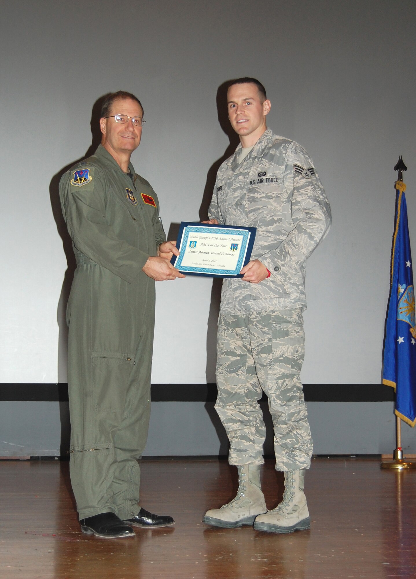 NELLIS AIR FORCE BASE, Nev. -- (Right) Senior Airman Samuel Dukes is recognized as the 926th Group's 2010 Airman of the Year by Col. Herman Brunke, 926th GP commander, during a commander's call here April 2. (U.S. Air Force photo/Capt. Jessica Martin)