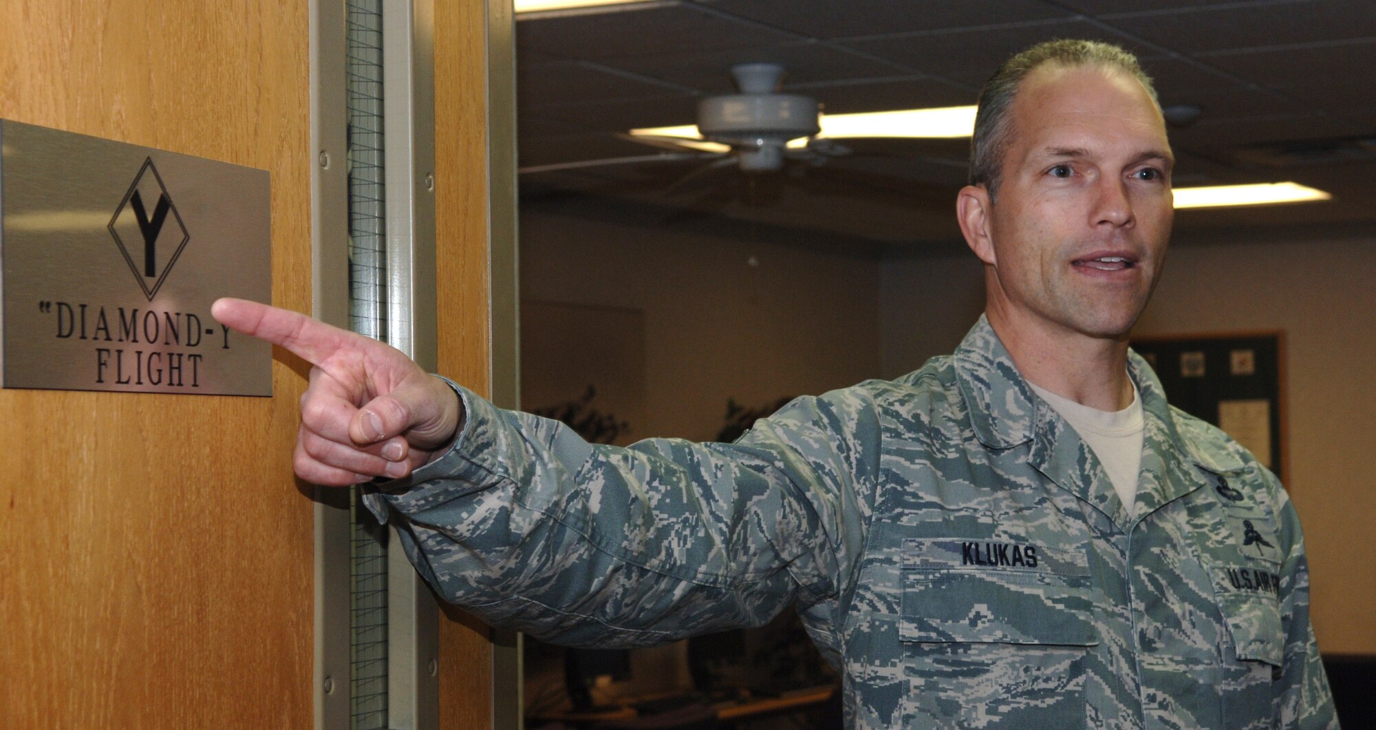 Chief Master Sgt. Martin Klukas, Air Combat Command command chief, points out the “Diamond-Y Flight” plaque at the Airman Leadership School on Ellsworth Air Force Base, S.D., April 15, 2011. Chief Klukas said the plaque was significant to him because his father flew 50 missions with the “Diamond Backs” of the 99th Bomb Group. (U.S. Air Force photo by Senior Airman Jarad A. Denton)