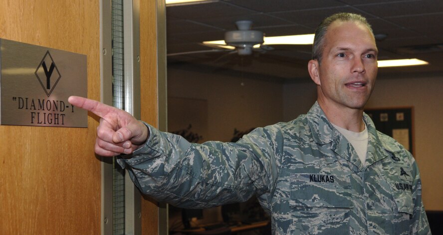 Chief Master Sgt. Martin Klukas, Air Combat Command command chief, points out the “Diamond-Y Flight” plaque at the Airman Leadership School on Ellsworth Air Force Base, S.D., April 15, 2011. Chief Klukas said the plaque was significant to him because his father flew 50 missions with the “Diamond Backs” of the 99th Bomb Group. (U.S. Air Force photo by Senior Airman Jarad A. Denton)