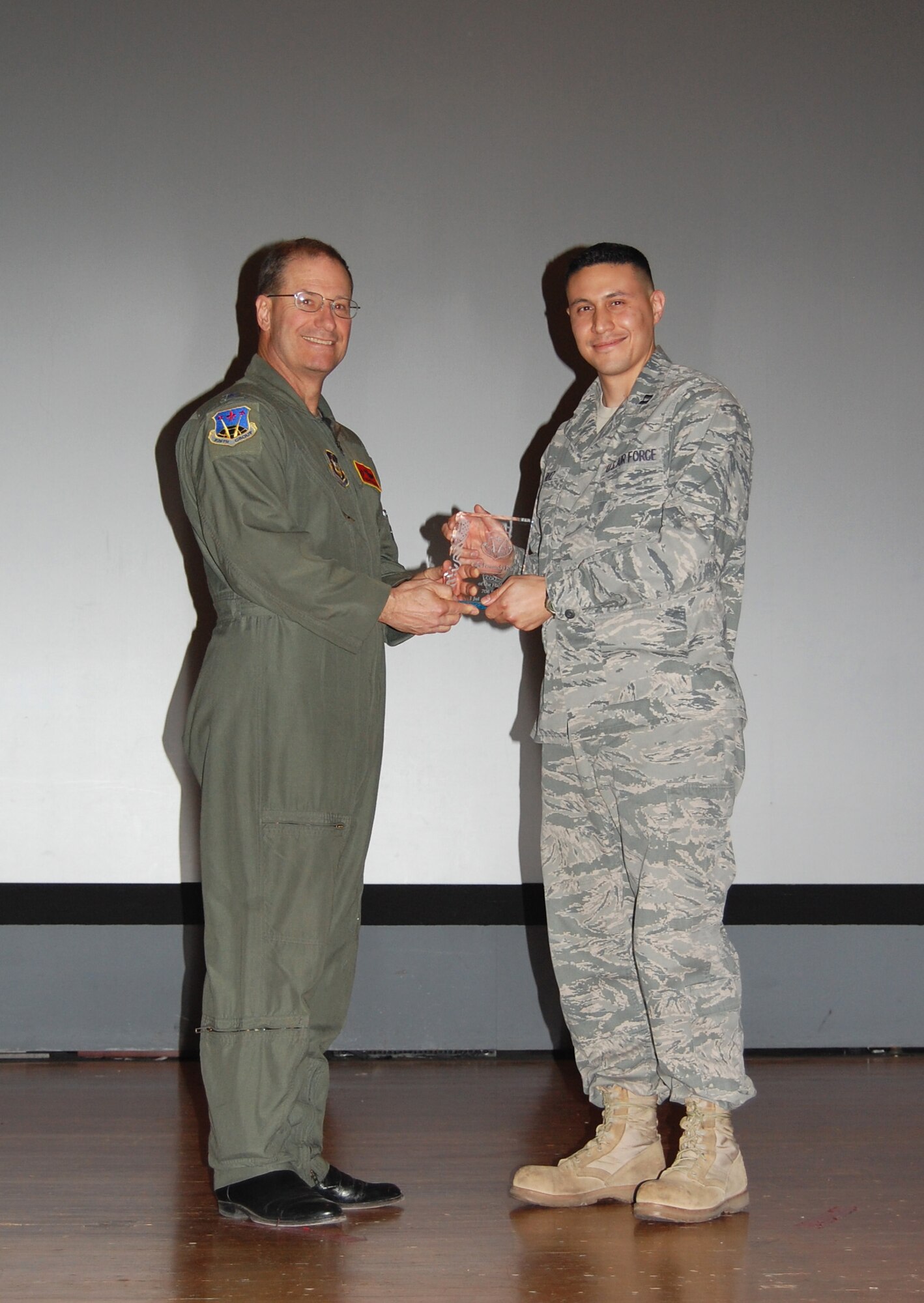 NELLIS AIR FORCE BASE, Nev. -- (Right) Capt. Fernando Ruiz, 706th Fighter Squadron director of information operations, is recognized as the 926th Group's 2010 Company Grade Officer of the Half by Col. Herman Brunke, 926th GP commander, during a commander's call here April 2. (U.S. Air Force photo/Capt. Jessica Martin)