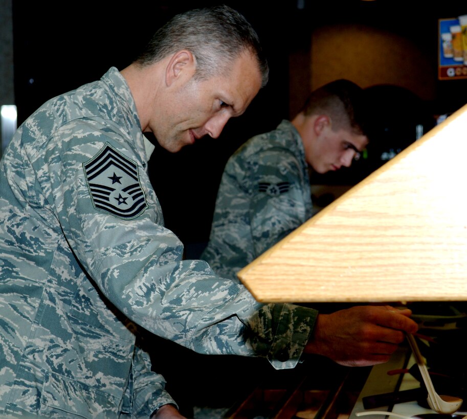 Chief Master Sgt. Martin Klukas, Air Command Command command chief, dines with swing and mid-shift Airmen at the Bandit Inn dining facility on Ellsworth Air Force Base, S.D., April 14, 2011. Chief Klukas used the dinner as a forum to listen to concerns from Airmen and answer their questions. (U.S. Air Force photo by Senior Airman Jarad A. Denton)