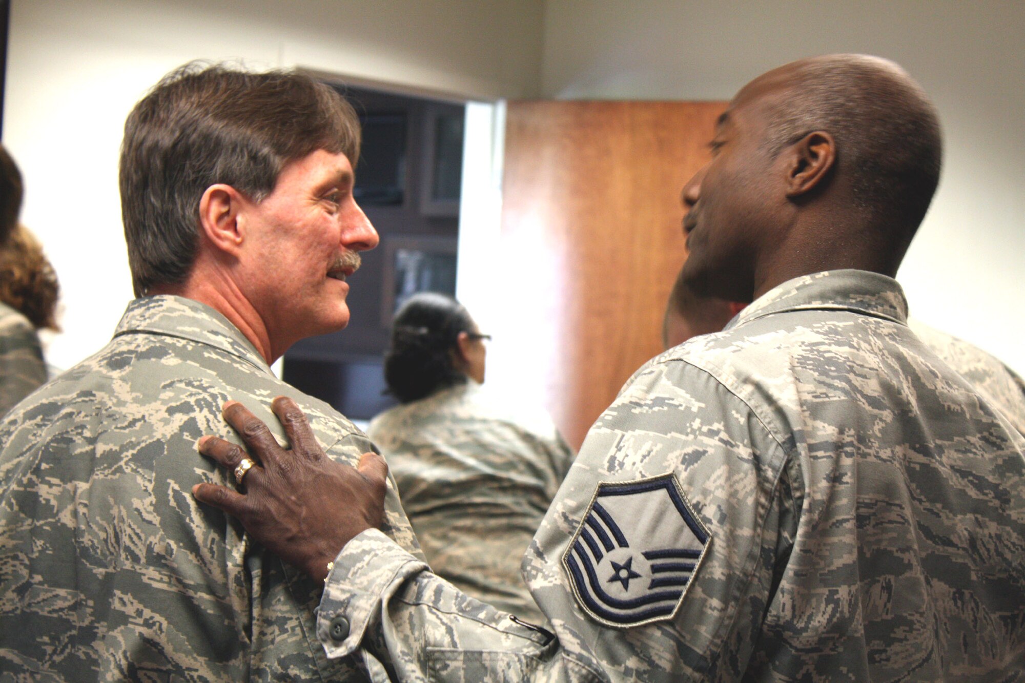 TRAVIS AIR FORCE BASE, Calif. -- Master Sgt. Grayland Hilt, 349th Air Mobility Wing equal opportunity, shares a memory with Chaplain (Lt. Col.) Greg Stringer. After 19 years of faithful service to the Golden Gate wing, the Chaplain is leaving for an individual mobilization augmentee position with Air Force Materiel Command. Wing staff bid the Chaplain a fond farewell on Apr. 10, 2011, as he has been a welcome fixture not only around the wing, but around Travis. We'll see you again, Sir! (U.S. Air Force photo/Senior Master Sgt. Ellen L. Hatfield)