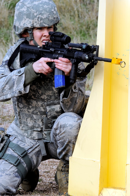 Staff Sgt. Kellie Werkmeister, 28th Security Forces Squadron response force leader, provides cover fire while her partner bounds forward during “Shoot, Move and Communicate,” drills  April 13, 2011, at Ellsworth Air Force Base. The “Shoot, Move and Communicate,” drills teach Airmen how to communicate while providing suppressive cover fire. (U.S. Air Force photo/Senior Airman Adam Grant)