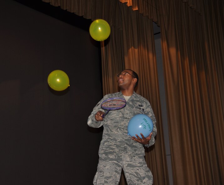 WRIGHT-PATTERSON AIR FORCE BASE, Ohio - Airman 1st Class Christopher Malone, 445th Security Forces Squadron, juggles balloons to demonstrate the struggle of managing military, civilian and family life as additional “stressor” balloons were added during the suicide prevention briefing at the April 10 commander’s call. The demonstration was aimed at reminding Airmen that helping agencies are available to assist military members that are struggling to juggle their own “balloons”. (U.S. Air Force photos/Senior Airman Senchia Chu)