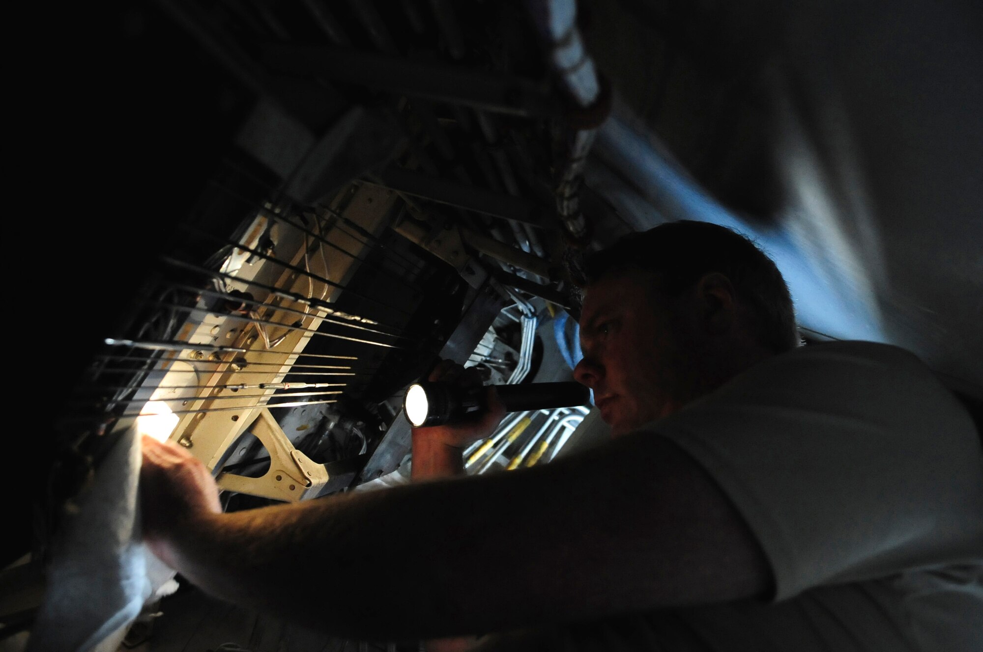 110414-F-UA979-003 -- WESTERN EUROPE (April 14, 2011) ? Tech. Sgt. Brett McVay, fuels cell technician, investigates a potential fuel leak in the aft boost pump in the wing of a KC-10 Extender. Sergeant McVay is deployed with the 313th Air Expeditionary Wing from the 349th Air Mobility Wing, Travis Air Force Base, Calif., in support of Operation Unified Protector. Operation Unified Protector is a NATO-led mission in Libya, to protect civilians and civilian-populated areas under threat of attack. The 313th AEW provides aerial refueling to U.S. and coalition aircraft with KC-135 Stratotankers and KC-10s. (U.S. Air Force photo/Senior Airman Ethan Morgan)