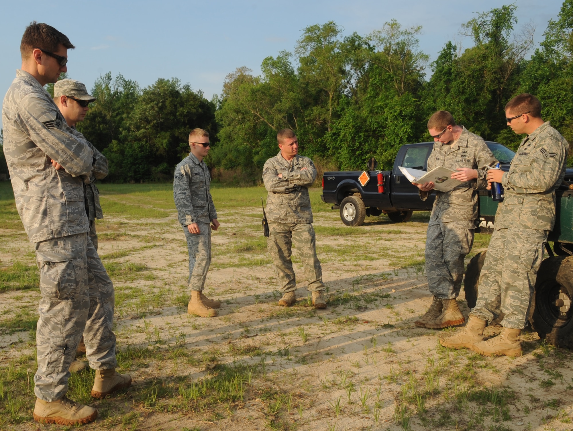 23rd Civil Engineer Squadron explosive ordnance disposal members listen to a range safety briefing before performing demolitions at Moody Air Force Base, Ga., April 15. This briefing is conducted prior to every range demolition to ensure EOD members are aware of all safety hazards while on the range. (U.S. Air Force photo/Airman 1st Class Douglas Ellis)(RELEASED)
