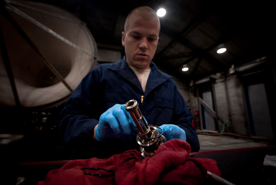 MOODY AIR FORCE BASE, Ga.-- Senior Airman Christian Franco, 23rd Component Maintenance Squadron propulsion flight test cell journeyman, prepares an oil filter for installation onto a TF-34 engine before an engine run April 14. An engine run is when an uninstalled engine is tested for functionality. Becoming certified to run this process takes six months of on-the-job training and a specialized two-day course. (U.S. Air Force photo/Airman 1st Class Joshua Green)(RELEASED)
