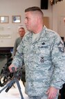 YOUNGSTOWN AIR RESERVE STATION, Ohio — Senior Master Sgt. Ron Mines, a Security Forces Squadron member with the 910th Airlift Wing here, briefs a group of Air Force Junior Reserve Officer Training Corps (AFJROTC) members on his deployment experiences and various Air Force Reserve weapon systems. Approximately 75 junior ROTC members from Midview High School's AFJROTC Program attended a base tour and orientation flight Wednesday. U.S. Air Force photo by Mr. Eric M. White.
