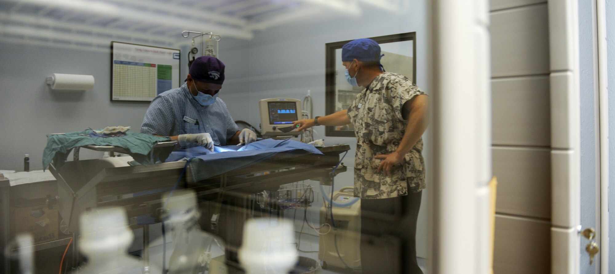 Veterinarians Dr. Darrin Olson and Technician Mike Bridges operate on a canine at the vet clinic on Barksdale Air Force Base, La., April 13. The clinic hours are Monday through Friday 9 a.m. - 12 p.m. and 1:30 pm to 4 p.m. The clinic is closed on weekends, federal holidays and the last working day of each month. (U.S. Air Force photo/Airman 1st Class Micaiah Anthony) (RELEASED)