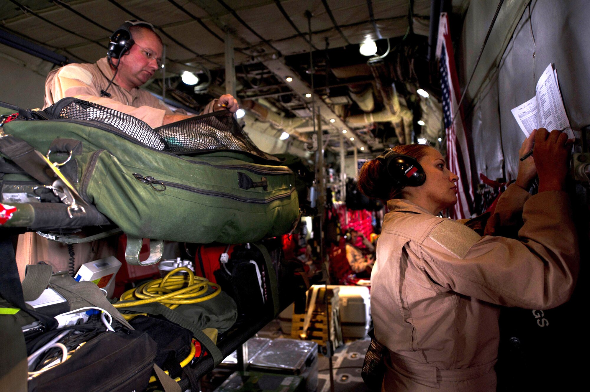 Master Sgt. James Bryon Freeman and Tech. Sgt. Rachel Anderson inventory medical equipment aboard a C-130 Hercules April 6, 2011, during an aeromedical evacuation mission in Southwest Asia. Sergeants Freeman and Anderson are aeromedical evacuation technicians assigned to the 379th Expeditionary Aeromedical Evacuation Squadron. (U.S. Air Force photo/Master Sgt. Adrian Cadiz)