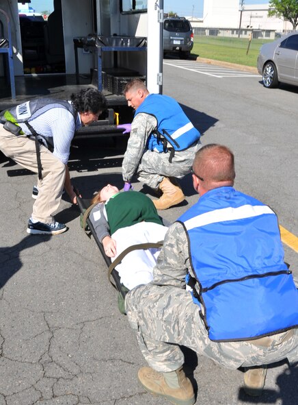 Members of the 19th Medical Group first responder team transport a simulated casualty after a major accident response exercise April 12, 2011, at Little Rock Air Force Base, Ark. Team Little Rock members participated in the MARE to stay current with their training in case of a real world event. (U.S. Air Force photo/Airman 1st Class Rusty Frank) 