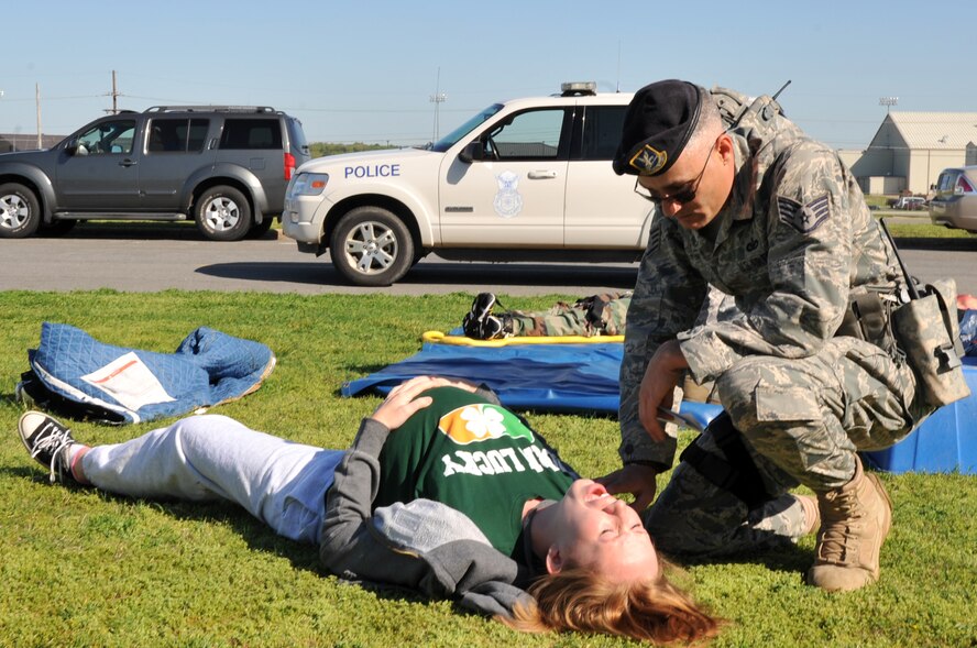 Staff Sgt. Jack Way, a 19th Security Forces Squadron patrolman, monitors a local area student’s vital signs during a major accident response exercise April 12, 2011, at Little Rock Air Force Base, Ark. The MARE enabled Airmen to practice procedures for the upcoming operation readiness inspection in October. (U.S. Air Force photo/Airman 1st Class Rusty Frank) 