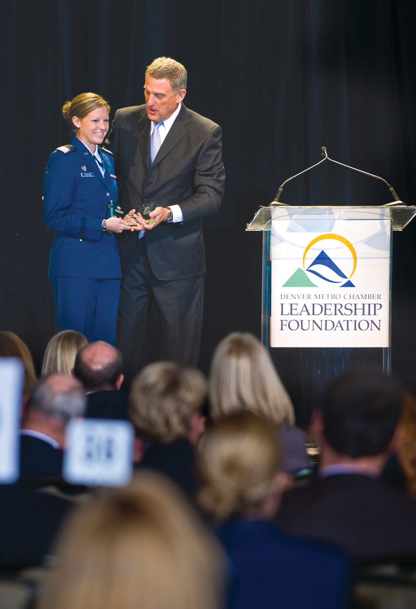Tim Schultz, President and CEO of the Boettcher Foundation presents Cadet 1st Class Megan Hoskins with the 2011 Colorado Leadership Alliance Student of the Year Award at the CLA Luncheon in Denver Tuesday.   (Photo by Joshua & Co. Photography)