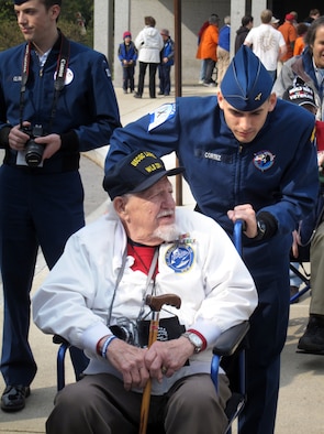Cadet 1st Class Joseph Cortez, Cadet Squadron 25, assists World War II veteran Fred Linke during their visit to the U.S. capital April 7-9. (U.S. Air Force Photo)