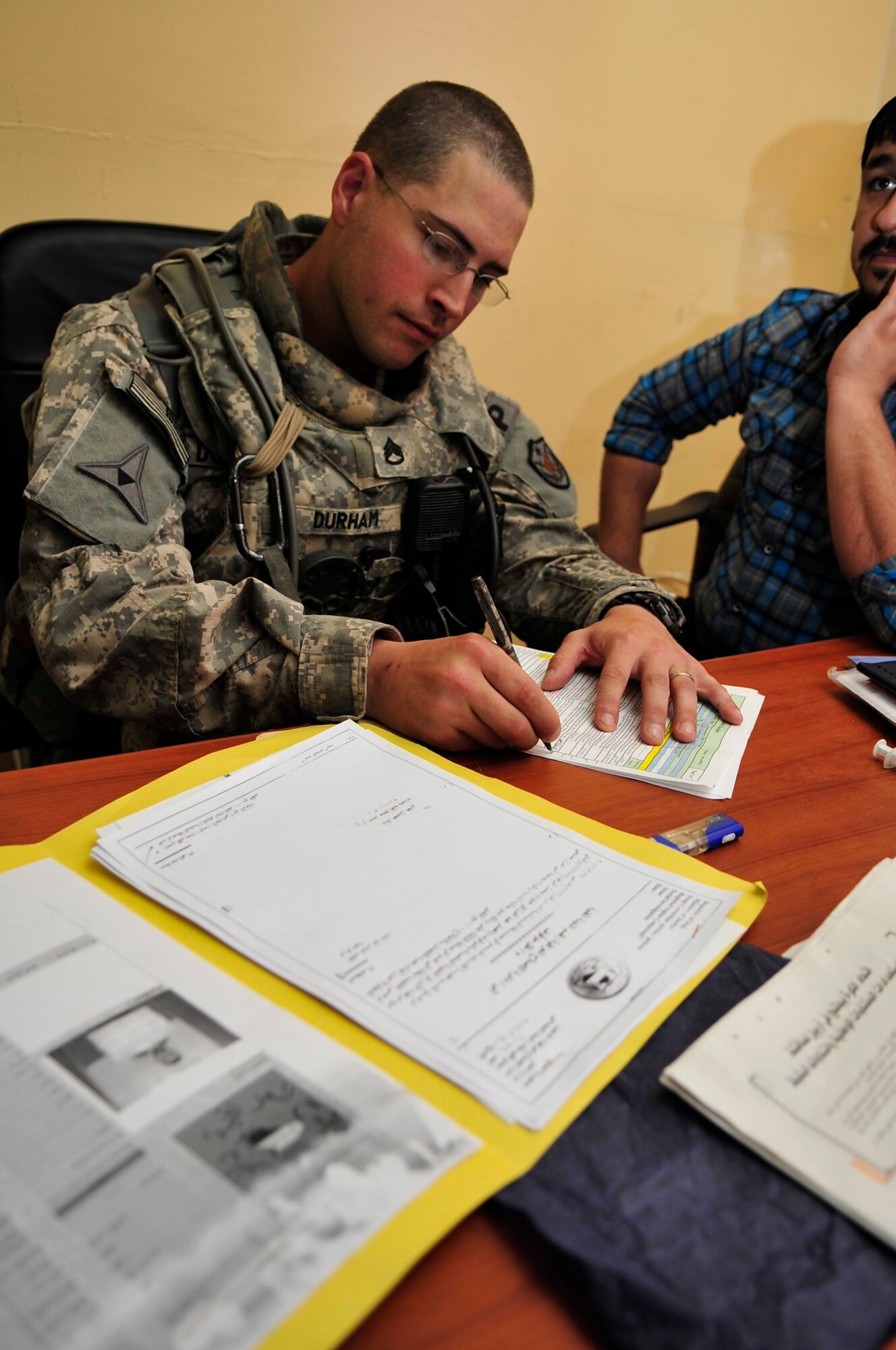 U.S. Army Staff Sgt. Benjamin Durham, U.S. Forces – Iraq provost marshal office corrections assistance transition team force protection assessor, reviews records kept inside the mental health clinic at a prison in Baghdad’s Rusafa Prison Complex, April 6, 2011. Sergeant Durham is conducting an assessment of conditions at the facility. (U.S. Air Force photo by Senior Master Sgt. Larry A. Schneck)