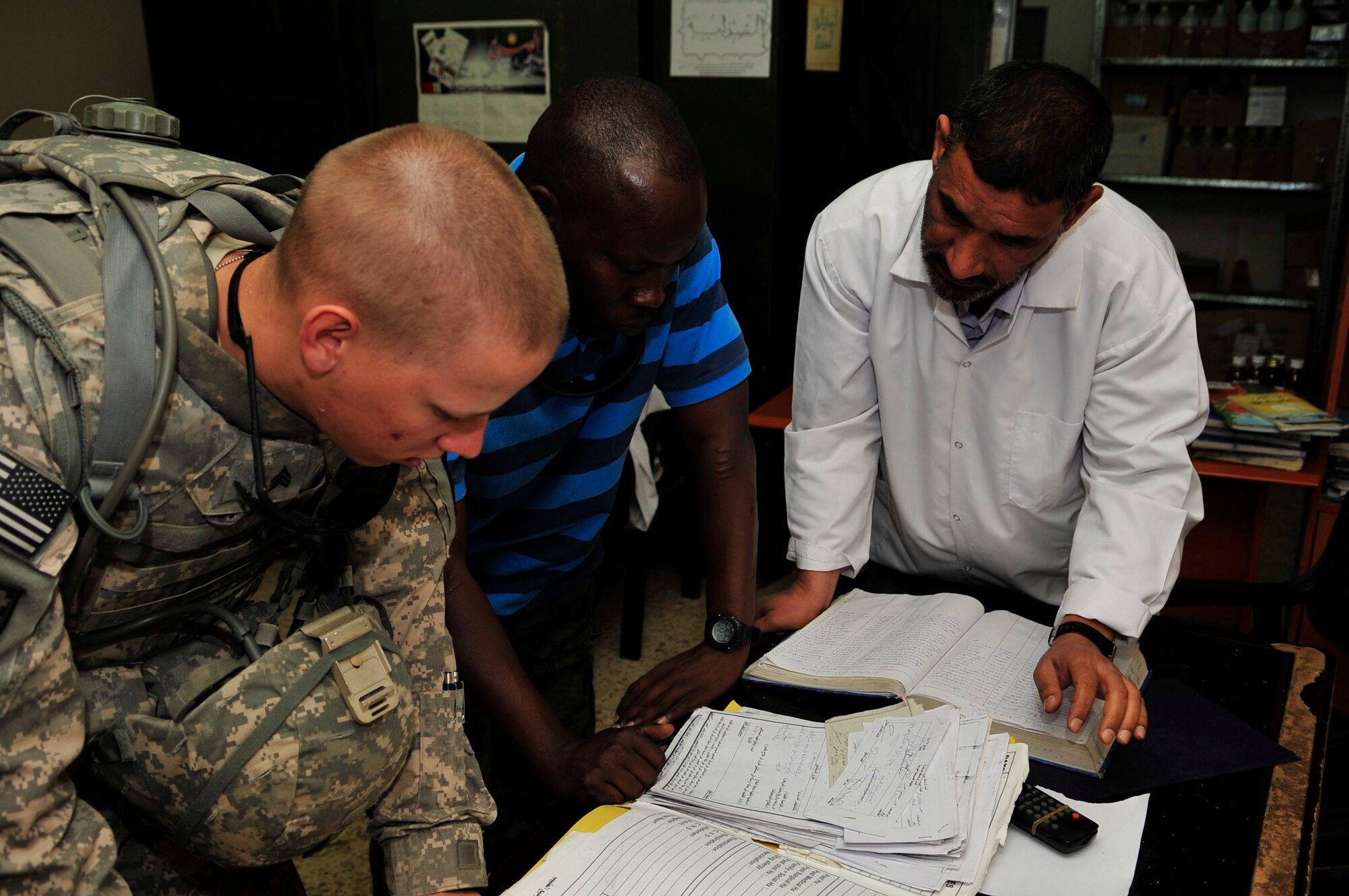 U.S. Army Sgt. Jesse Jeannette, U.S. Forces – Iraq provost marshal office corrections assistance transition team medical assessor, reviews an inmate’s medical record with an interpreter and an Iraqi doctor in a prison in Baghdad’s Rusafa Prison Complex, April 6, 2011. Sergeant Jeannette is conducting an assessment of medical conditions at the facility. (U.S. Air Force photo by Senior Master Sgt. Larry A. Schneck)