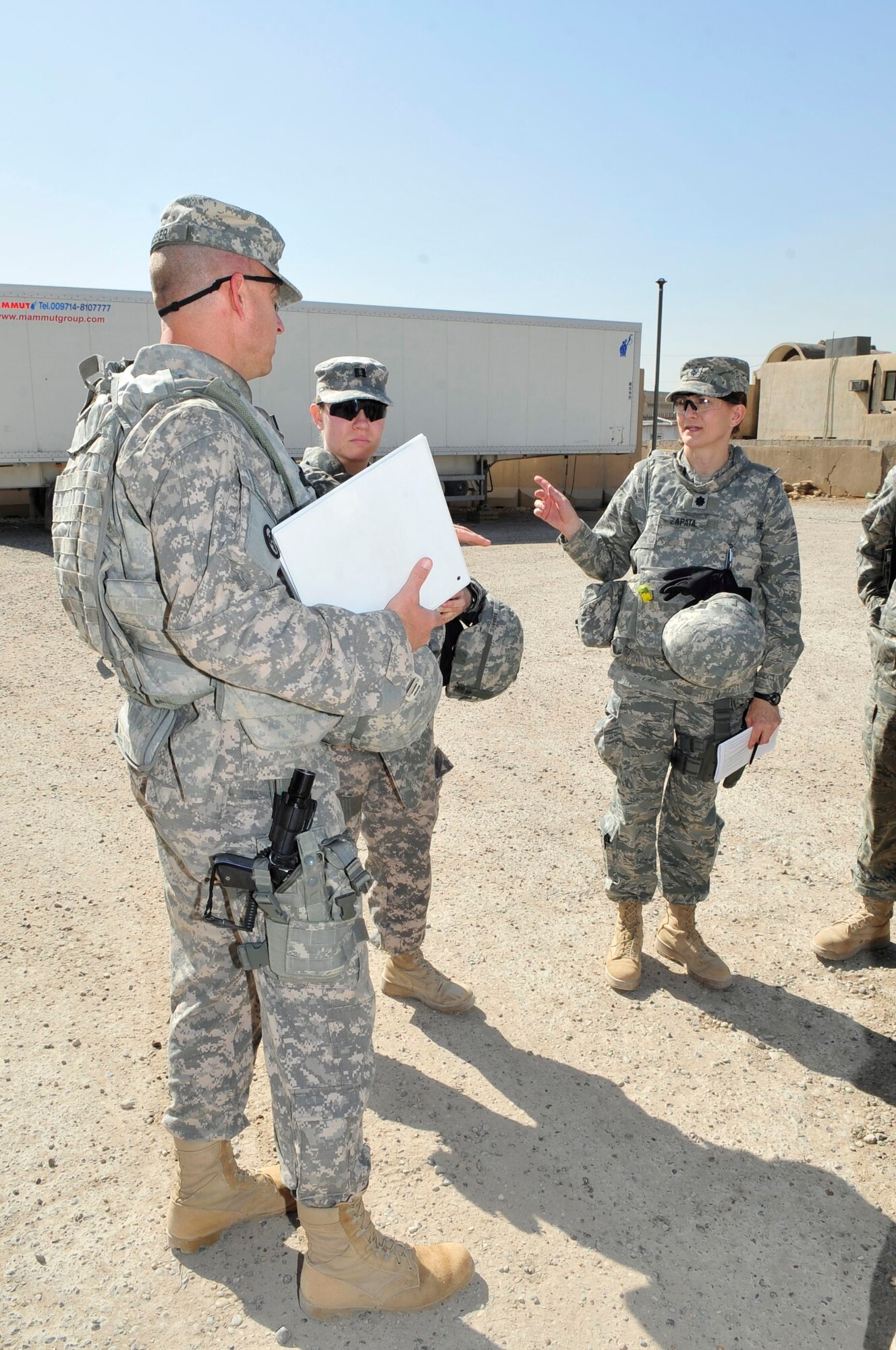 From left to right, U.S. Army Capt. Mark Weber, U.S. Forces – Iraq corrections assistance transition team officer in charge, from Greenfield, Iowa., U.S. Army Capt. Kristen Berdahl and U.S. Air Force Lt. Col. Kaylin Haywood Zapata discuss preparation for a mission at Joint Security Station Shield, Iraq, April 6, 2011. Before going outside-the-wire to assess the conditions at a women’s prison in Baghdad’s Rusafa District, these members of the corrections assistance transition team go over checklists of questions they will ask Iraqi officials at the facility. (U.S. Air Force photo by Senior Master Sgt. Larry A. Schneck)