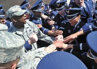 Chief Master Sgt. Juan Lewis, 502nd Air Base Wing command chief, celebrates with Joint Base San Antonio Honor Guard members after a graduation ceremony April 6. The honor guard members completed the USAF Honor Guard base honor guard training program, an 8-day course specializing in military funeral honors. (U.S. Air Force photo/Alan Boedeker)