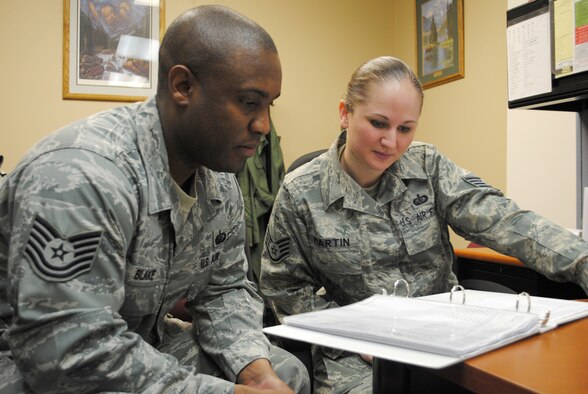 Tech. Sgt. Farrel Blake, the noncomissioned officer in charge of missile chefs, and Staff Sgt. Chloe Martin, assistant NCOIC of missile chefs look over training information together.  Sergeant Martin works hand-in-hand with Sergeant Blake every day to ensure the smooth transition of chefs in and out of the missile fields. (U.S. Air Force photo/Airman Cortney Hansen)