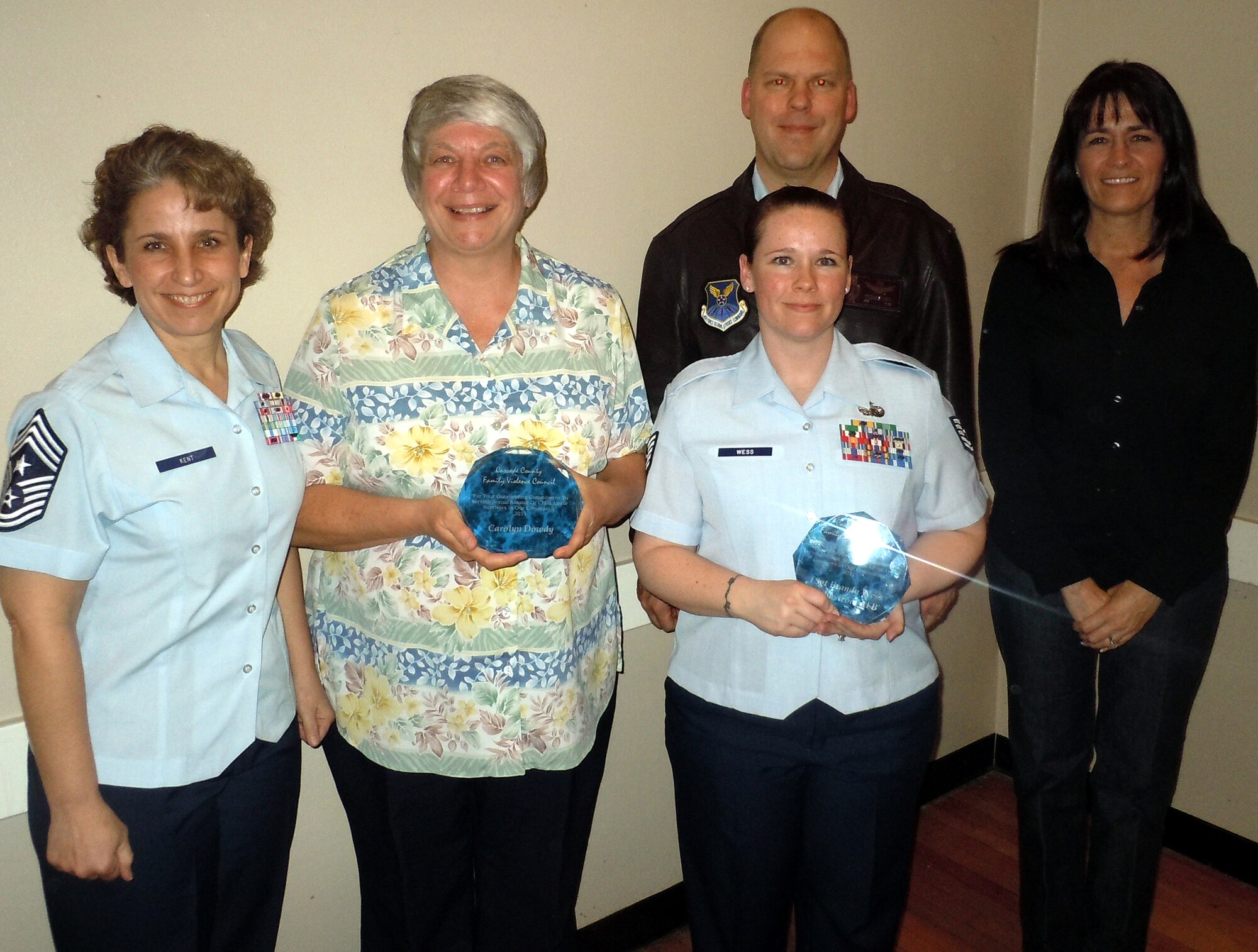 Chief Master Sgt. Cari Kent, 341st Missile Wing command chief (left) and Col. Stephen Davis, 341st MW vice commander (back), and Lori Muzzana, 341st MW Sexual Assault Repornse Coordinator,  pose for a photo with award winners Carolyn Dowdy and Tech. Sgt. Brandy Wess.  The two were among several community members recognized for outstanding commitment to serving sexual assault or chld abuse survivors in the community. Ms. Dowdy and Sergeant Wess are part of the base's sexual assault prevention and response team. (U.S. Air Force photo/Seniro Master Sgt. Tom Johnson)