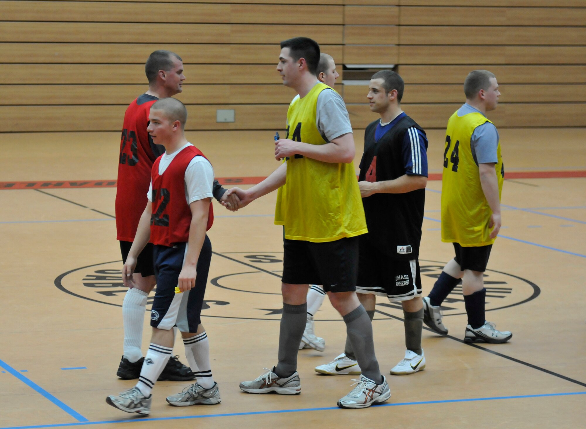 SPANGDAHLEM AIR BASE, Germany- The 702nd Munitions Support Squadron and 52nd Civil Engineer Squadron team members shake hands after an intramural soccer game April 14 at the Skelton Memorial Fitness Center. The 702nd MUNSS defeated the 52nd CES 6-3. (U.S. Air Force photo/Airman 1st Class Brittney Frees)