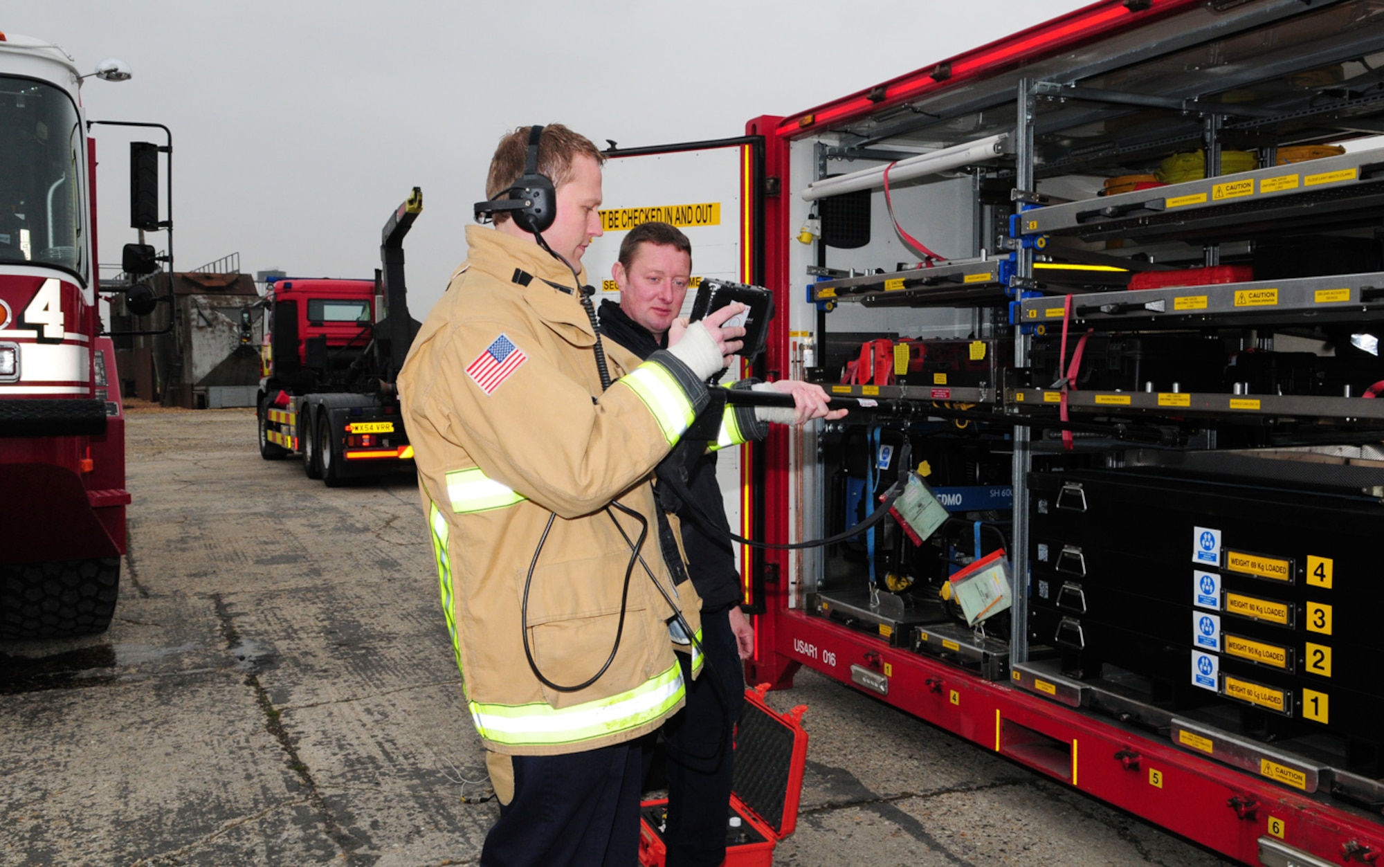 RAF MILDENHALL, England -- Firefighter Simon Law, 100th Civil Engineer Squadron Fire Department tests out a searchcam, assisted by David Jackson, Norfolk Urban Search and Rescue, March 30, 2011. Four members from NUSR brought two modules of rescue equipment to show and demonstrate to the RAF Mildenhall firefighters. (U.S. Air Force photo/Karen Abeyasekere)