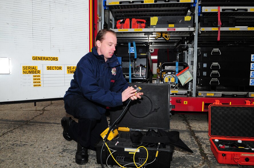 RAF MILDENHALL, England -- Matthew Bensley, Norfolk Urban Search and Rescue, assembles a snake-eye camera, a hand-held, remote video-inspection system used to inspect hard-to-reach areas such as behind walls, inside ceilings and under vehicles and aircraft. The NUSR team also have searchcams, used to locate people or animals trapped in voids (collapsed spaces where people can survive, such as when a building collapses). They also have electronic listening devices specifically for search and rescue, to locate missing people or animals, which pick up sound and seismic movement and vibration. The NUSR team are specialist firefighters who respond to technical rescue-based incidents, such as a building collapse, water rescue or confined-space rescue. John Linden, NUSR watch manager who was part of a team visiting RAF Mildenhall March 30, 2011, said training such as this promotes a good working relationship between the two teams (on- and off-base firefighters) and they plan on doing training exercises together in the future. (U.S. Air Force photo/Karen Abeyasekere)