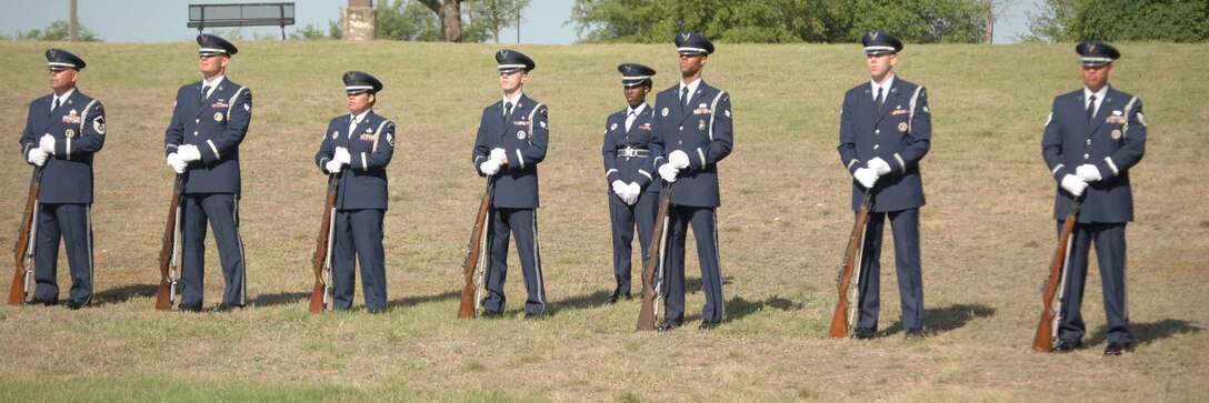 Members of the Joint Base San Antonio Honor Guard stand by with their rifles while waiting for their graduation to begin. The graduation was a milestone for San Antonio as it was the first Joint Base Honor Guard graduation and celebrated the dedicated time of Active-Duty, Reserve and National Guard members assigned to Lackland and Randolph Air Force Bases.  (U.S. Air Force photo/ Senior Airman Viola M. Hernandez) 