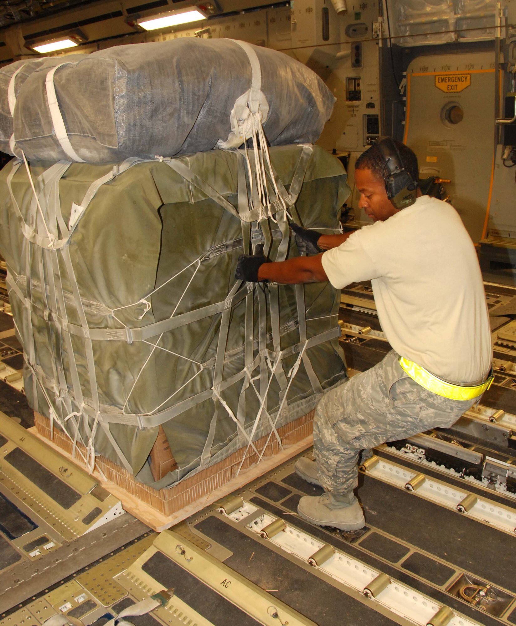 Tech. Sgt. Ronald Johnson, 8th Expeditionary Air Mobility Squadron, pulls a fully rigged pallet onto a C-17.  (U.S. Air Force photo/Staff Sgt. Anthony Graham)