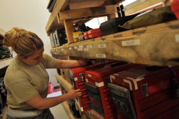 Staff Sgt. Heather Fraser, 455th Expeditionary Aircraft Maintenance Squadron, pulls out a tool-kit from a consolidated tool-kit office Bagram Airfield, Afghanistan, April 6, 2011. The CTK has over 7,000 tools inventoried. Sergeant Fraser is deployed from the Delaware Air National Guard. (U.S. Air Force photo by Senior Airman Sheila deVera)