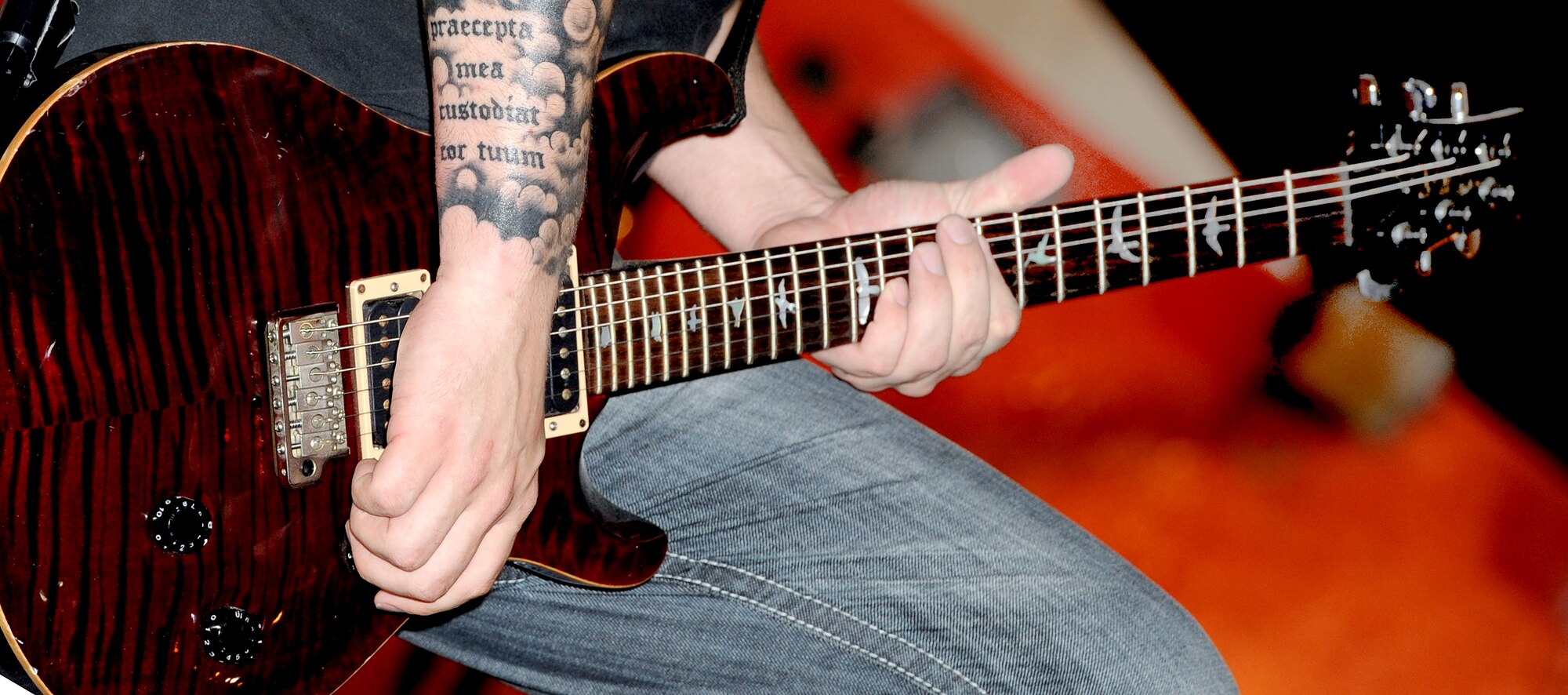Lead singer Benjamin Bird from the Along Those Lines alternative rock band, plays the guitar during an Armed Forces entertainment live show at Memorial Plaza, April 13 in Southwest Asia. (U.S. Air Force photo/Staff Sgt. Liliana Moreno)              