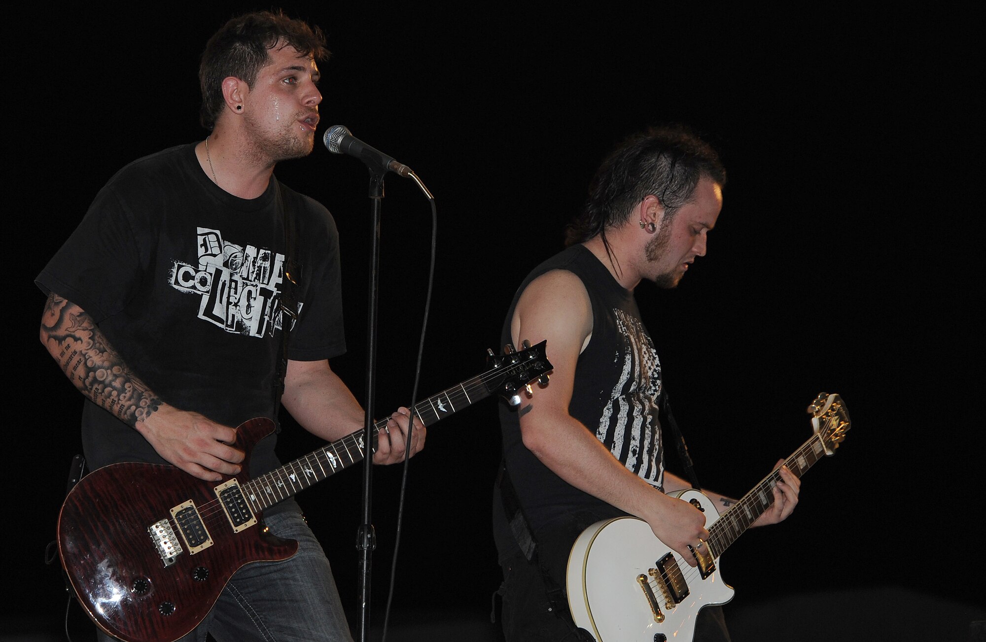 Lead singer Benjamin Bird and lead guitarist Will Trenum from the Along Those Lines alternative rock band, perform during an Armed Forces entertainment live show at Memorial Plaza, April 13 in Southwest Asia. (U.S. Air Force photo/Staff Sgt. Liliana Moreno)                        