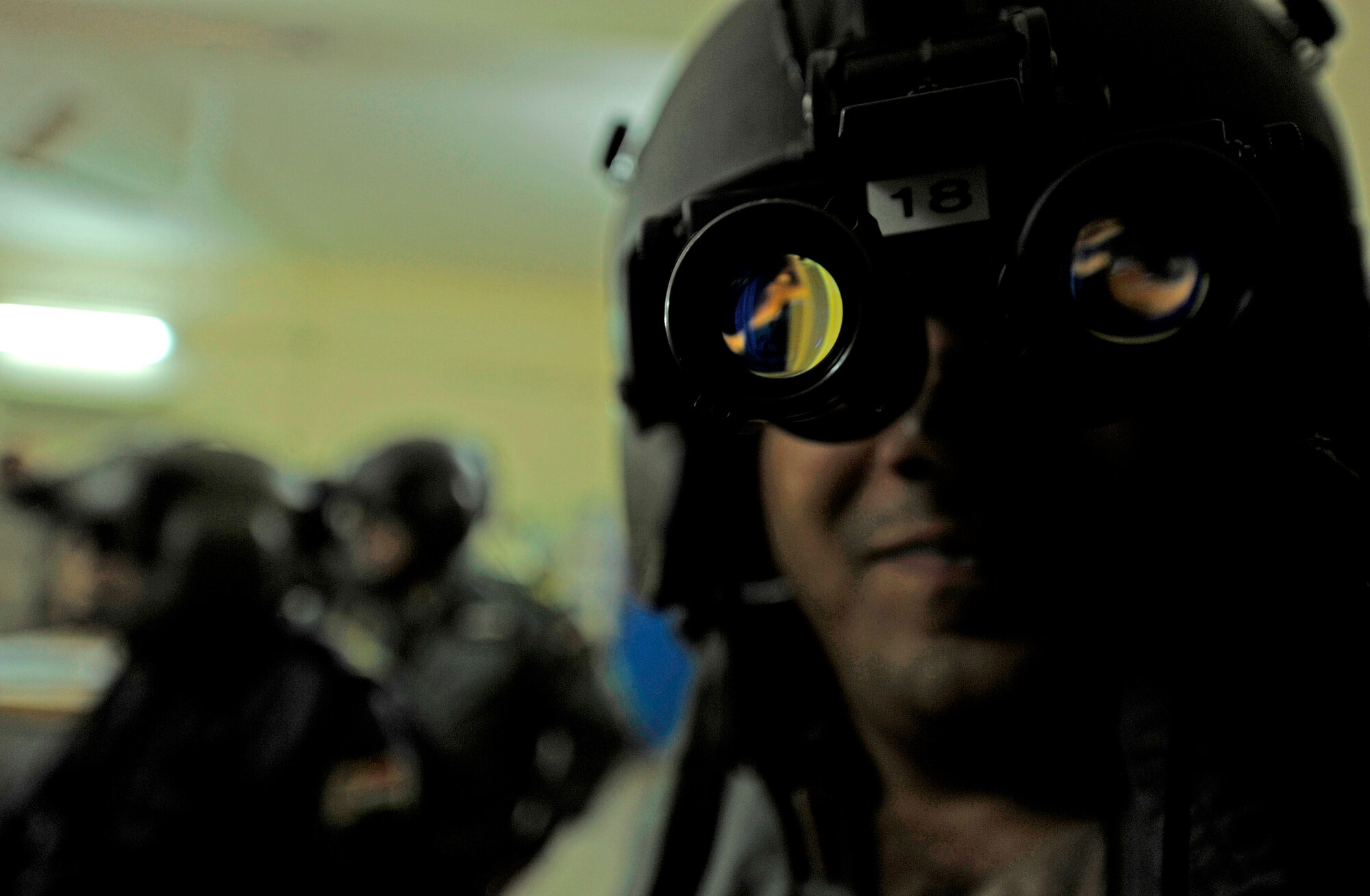 CAMP TAJI, Iraq -- Huey helicopter pilots from Iraqi Army Aviation Command's Squadron 20 set up night vision goggles on their helmets prior to the final UH-1 Huey mission with American instructors on board March 15. After more than five years in the cockpit with Iraqi copilots, 721st Air Expeditionary Advisory Squadron UH-1 Huey pilots have stepped out of the cockpit to advise their Iraqi partners on more strategic issues from the ground. (U.S. Air Force/Tech. Sgt. Jason Lake)