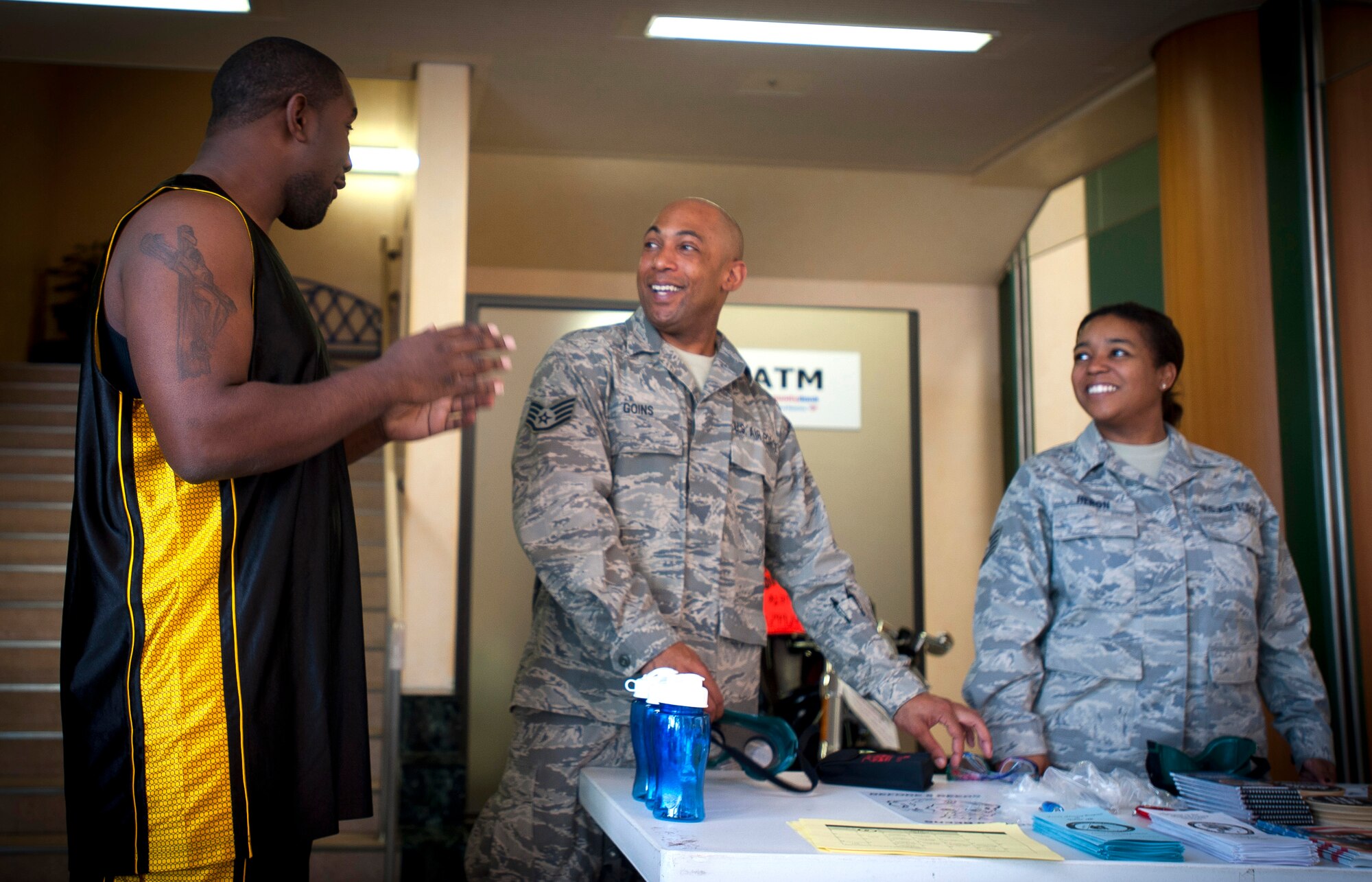 YOKOTA AIR BASE, Japan -- Staff Sgt. Shaun Stallworth, 374th Maintenance Squadron crew chief, talks with Tech. Sgt. Carolyn Heron and Staff Sgt. Brandon Goins, 374th Mental Health technicians here April 15, 2011. Representatives from the 374th Mental Health Clinic were at the Yokota Community Center handing out alcohol abuse information in support of Alcohol Awareness month. (U.S. Air Force photo illustration/Staff Sgt. Chad C. Strohmeyer)