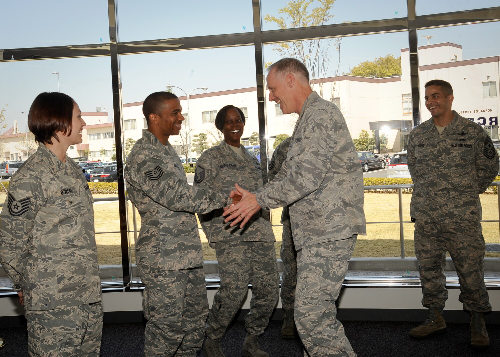 YOKOTA AIR BASE, Japan -- Col. Otto Feather, 374th Airlift Wing commander and Chief Master Sgt. Ben Caro, 374th AW command chief congratulate Tech. Sgt. Andy Gilbert here April 14, 2011. Sergeant Gilbert was awarded the Air Force-level Enlisted Professional Military Education NCO of the Year. (U.S. Air Force photo/Airman 1st Class Andrea Salazar)
