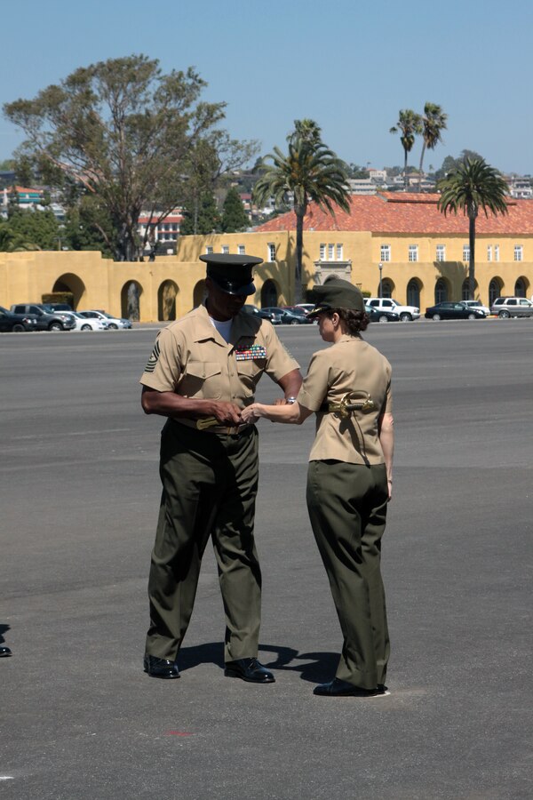 Sgt. Maj. Donald Jones hands the noncommisioned officers sword to Col. Stephanie Smith, Headquarters and Service Battalion commanding officer, during a relief and appointment ceremony held at Shepherd's Field Friday. "It was my honor and priviledge to have known and worked beside the Marines (aboard the depot)," said Jones. "I'm not sad; I'm not going to cry; my eyes may tear up, but I'm not crying. This is a happy day." Jones was relieved by Sgt. Maj. Michael D. Brookman.
