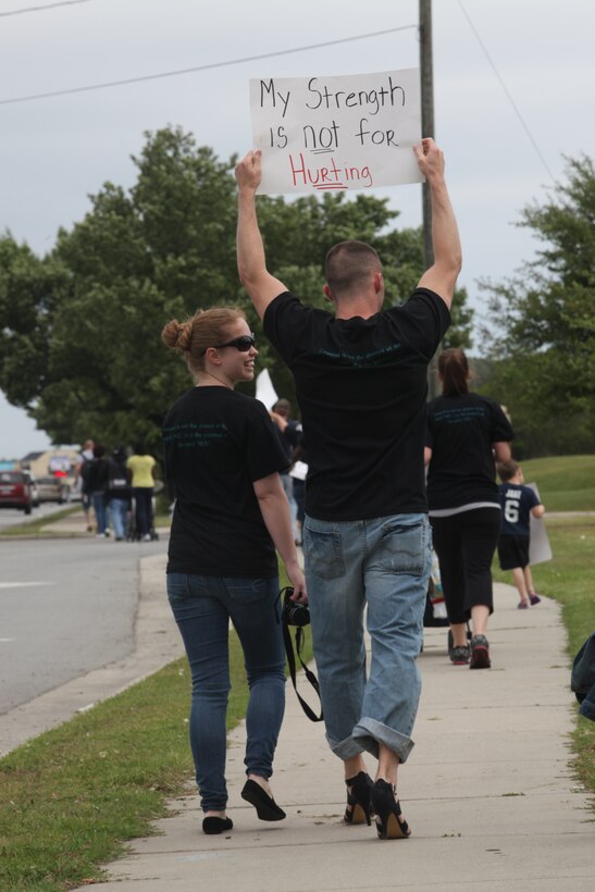 Staff Sgt. Jeremy Burns shows his support in high heels for the fight against sexual assault during the “Walk a Mile in Her Shoes” march April 16 on Western Boulevard. More than 150 people attended the mile-long initiative to make people aware about the severity of sexual assault. Burns is a court reporter for Combat Logistics Regiment 27, 2nd Marine Logistics Group.