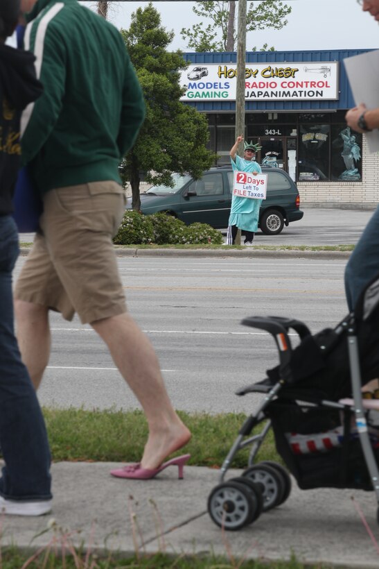 The tax man shows his support for the men in high heels who walked in the “Walk a Mile in Her Shoes” march April 16 on Western Boulevard. More than 150 people joined the march which is an opportunity for men to raise awareness in their community about the serious causes, effects and remediations to sexualized violence.