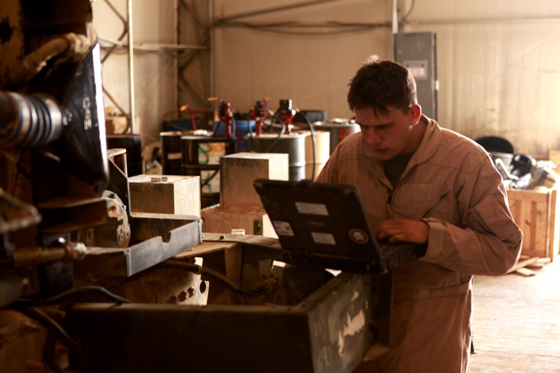 Lance Cpl. Jason R. Hartigan, from Sarasota, Fla., a motor transportation mechanic with 2nd Maintenance Battalion (-) (Reinforced), 2nd Marine Logistics Group (Forward), looks for instructions on a computer as he works on a wrecker April 16, 2011, aboard Camp Leatherneck, Afghanistan.   Marines with the Motor Transportation Maintenance Platoon work 24 hours a day, seven days a week to repair any vehicle the Marine Corps has from the smaller Mine Resistant Ambush Protected All-Terrain Vehicle to the heavy Logistics Vehicle System Replacement, the largest logistic vehicle in the arsenal, for every unit supporting International Security Assistance Force operations throughout Helmand Province, Afghanistan. (Photo by Lance Cpl. Bruno J. Bego)