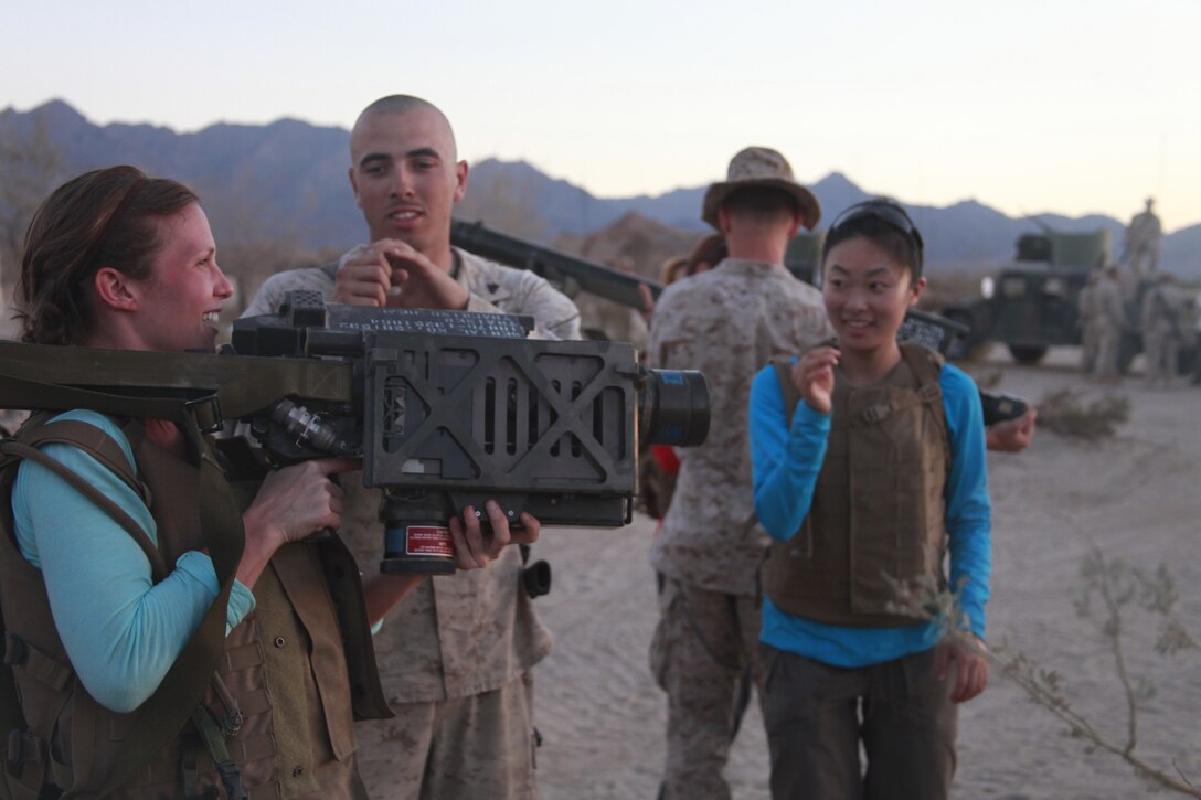 Amanda M. Penner, a student of the strategic studies program at Johns Hopkins School of Advanced International Studies, is taught how to properly hold an FIM-92A Stinger weapon system by a 3rd Low Altitude Air Defense Battalion Marine at the weapons and tactics instructor course at Marine Corps Air Station Yuma, Ariz., April 16.