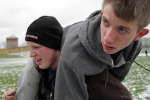 Mark Elmore, 18, from Edina, Minn., carries Calvin Poling, 17, from Minneapolis, during the modified combat fitness test portion of Recruiting Substation Bloomington's Family Day April 16. For more photos of the event, visit www.facebook.com/rstwincities.