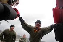 Sgts. Daniel Zevnik, 27, from Milwaukee, Wis., and Tony Kaiser, 30, from Eau Claire, Wis., motivate two Marine applicants while Sgt. Nicolas Magallanes, 32, from Lubbock, Texas, readies them for a pugil sticks session during Recruiting Substation Bloomington's Family Day April 16. The three Marines are recruiters at the Bloomington, Minn., substation. For more photos of the event, visit www.facebook.com/rstwincities.